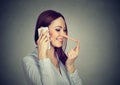 Happy young woman with long nose talking on mobile phone