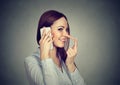 Happy young woman with long nose talking on mobile phone