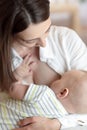 Happy young woman looking at baby. Healthy nutrition, breastfeeding and maternity concept. Royalty Free Stock Photo