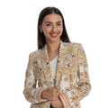 happy young woman looking forward, smiling and adjusting jacket Royalty Free Stock Photo