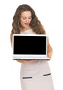 Happy young woman looking on laptop blank screen Royalty Free Stock Photo