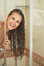 Happy young woman looking out from shower cabin Royalty Free Stock Photo