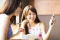 Happy young woman looking at phone in coffee shop Royalty Free Stock Photo