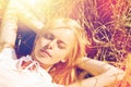 Happy young woman lying on cereal field or hay Royalty Free Stock Photo