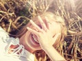 Happy young woman lying on cereal field Royalty Free Stock Photo