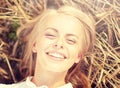 Happy young woman lying on cereal field Royalty Free Stock Photo