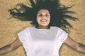 Happy young woman lying down on the dried grass Royalty Free Stock Photo