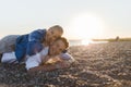 Happy young woman lying on her boyfriends back, looking at camera, having fun together. Royalty Free Stock Photo