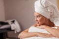 Happy young woman lying on massage table in spa salon . Royalty Free Stock Photo