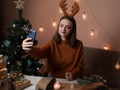 a happy young woman makes an order by phone, the girl has New Year's