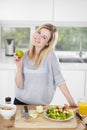 Nothing beats eating right and feeling great. Happy young woman making healthy food choices at home. Royalty Free Stock Photo