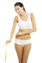 Happy young woman measuring her waist Royalty Free Stock Photo