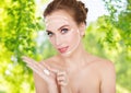 Happy young woman with moisturizing cream on hand Royalty Free Stock Photo