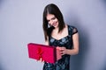 Happy young woman opening gift box Royalty Free Stock Photo