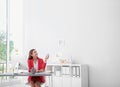 Happy young woman operating air conditioner Royalty Free Stock Photo