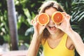 Happy young woman with oranges