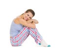 Happy young woman in pajamas sitting on floor Royalty Free Stock Photo