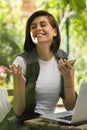 Happy young woman with phone and laptop Royalty Free Stock Photo