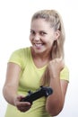 Happy young woman playing video game with joystick