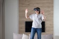 Happy young woman playing on VR glasses indoor, Virtual reality concept with young girl having fun with headset goggles Royalty Free Stock Photo