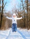 Happy young woman plays with snow