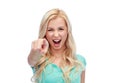Happy young woman pointing finger to you Royalty Free Stock Photo