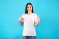 Happy young woman pointing fingers at t-shirt Royalty Free Stock Photo