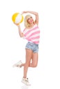 Happy young woman posing with a beach ball Royalty Free Stock Photo