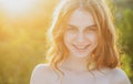 Happy young woman posing outdoor. Teen smiling girl in summer casual outfit. Outdoor female portrait. Royalty Free Stock Photo