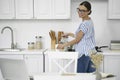 Gladsome lady looking at laptop and pouring coffee stock photo