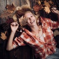 Happy young woman are preparing for autumn sunny day. Funny fac . Smile girl lies on wooden background and dreams of