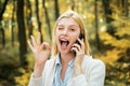 Happy young woman preparing for autumn sunny day. Happy girl posing with phone. Social media phone. Phone happy outdoor Royalty Free Stock Photo