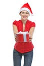 Happy young woman presenting Christmas gift box