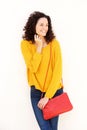 Happy young woman with purse against white background Royalty Free Stock Photo