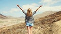 Happy young woman raises hands up on a hiking trail on top of the mountain, view from the back, Tenerife, Canary Islands Royalty Free Stock Photo