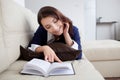 Happy young woman reading book at home Royalty Free Stock Photo