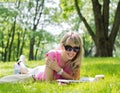 Happy young woman reading magazine in park Royalty Free Stock Photo