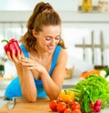 Happy young woman ready to make fresh vegetable sala Royalty Free Stock Photo