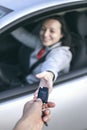 Happy young woman receiving the keys of her new car Royalty Free Stock Photo