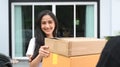 Young woman receiving package box from delivery man. Royalty Free Stock Photo