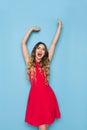 Happy Young Woman In Red Dress Is Shouting With Arms Raised Royalty Free Stock Photo