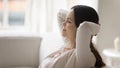 Happy young woman relax on sofa sleeping or dreaming