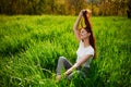 Happy young woman relaxing on a beautiful summer field. Royalty Free Stock Photo