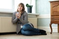 Happy young woman relaxing at home with a cup of tea Royalty Free Stock Photo