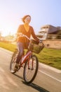 Happy young woman ride by bicycle