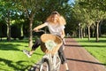 Happy young woman riding bike on road in park, beautiful hipter teenager having fun and laughing Royalty Free Stock Photo