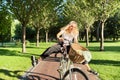 Happy young woman riding bike on road in park, beautiful hipter teenager having fun and laughing Royalty Free Stock Photo