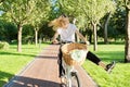 Happy young woman riding bike on road in park, beautiful hipter teenager having fun and laughing Royalty Free Stock Photo