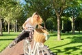 Happy young woman riding bike on road in park, beautiful hipter teenager having fun and laughing Royalty Free Stock Photo