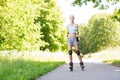 Happy young woman in rollerblades riding outdoors Royalty Free Stock Photo